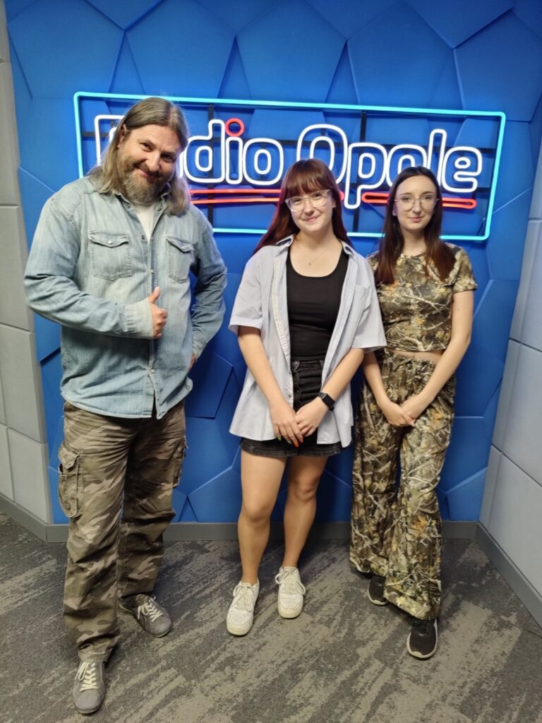 trzy osoby stojące w pomieszczeniu na tle napisu radio opole